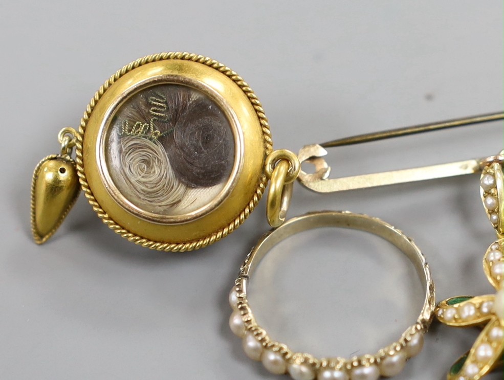 A Victorian yellow metal and seed pearl set drop mourning pendant, with plaited hair verso, 32mm, a yellow metal and split pearl set half hoop ring, a 15ct and seed pearl set flower head pendant on a 9ct bar suspension b